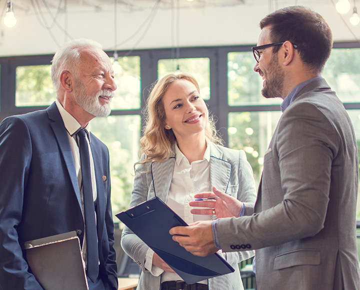 Smiling employees talking after a meeting